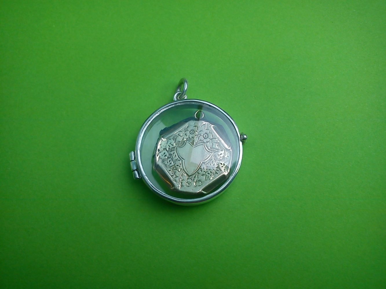 Outer locket made in silver with crystal watch cases so you can see the treasured inner locket which was badly damaged. Repurposed.